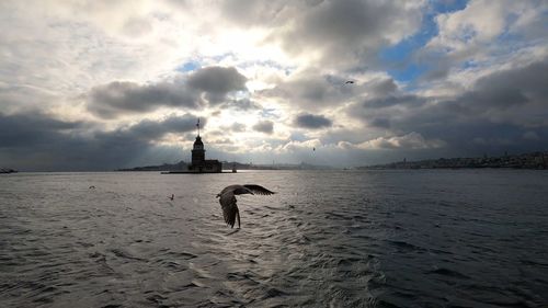 View of lighthouse in sea against sky