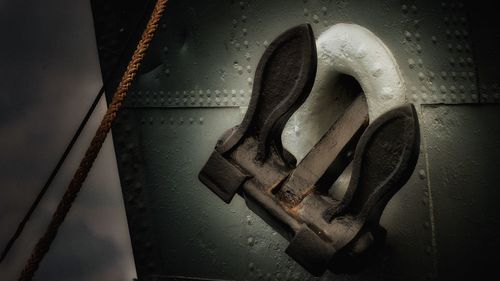 High angle view of rusty chain on wet metal