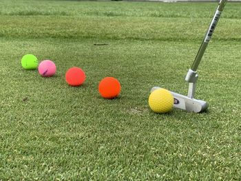 Close-up of golf ball on grassland