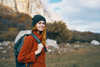 Young woman wearing hat while standing on land