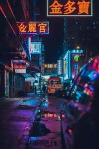 Illuminated city street at night