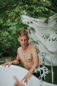 Portrait of shirtless man in water