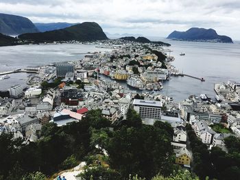 High angle view of cityscape against cloudy sky