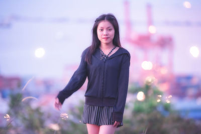 Portrait of young woman standing outdoors