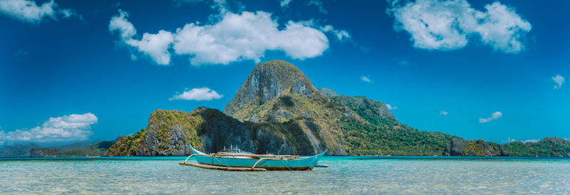 Panoramic view of sailboat in sea against sky