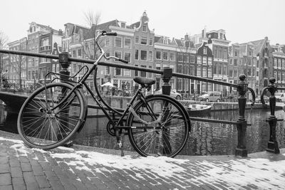 Bicycles on street by buildings in city