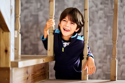 High angle view of young woman sitting on railing