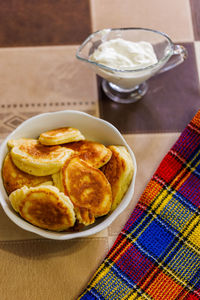 Homemade russian pancakes on ceramic bowl on dinner table