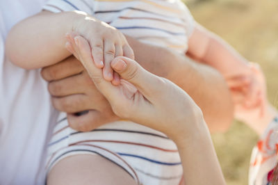 Close-up of couple holding hands