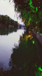 Reflection of trees in lake against sky