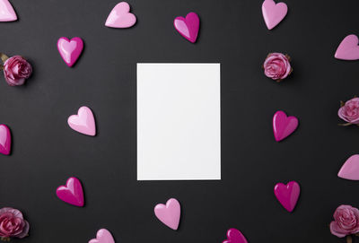 High angle view of heart shaped paper against black background