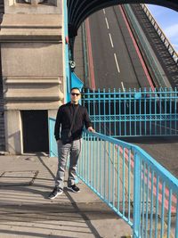 Portrait of smiling man standing on tower bridge 