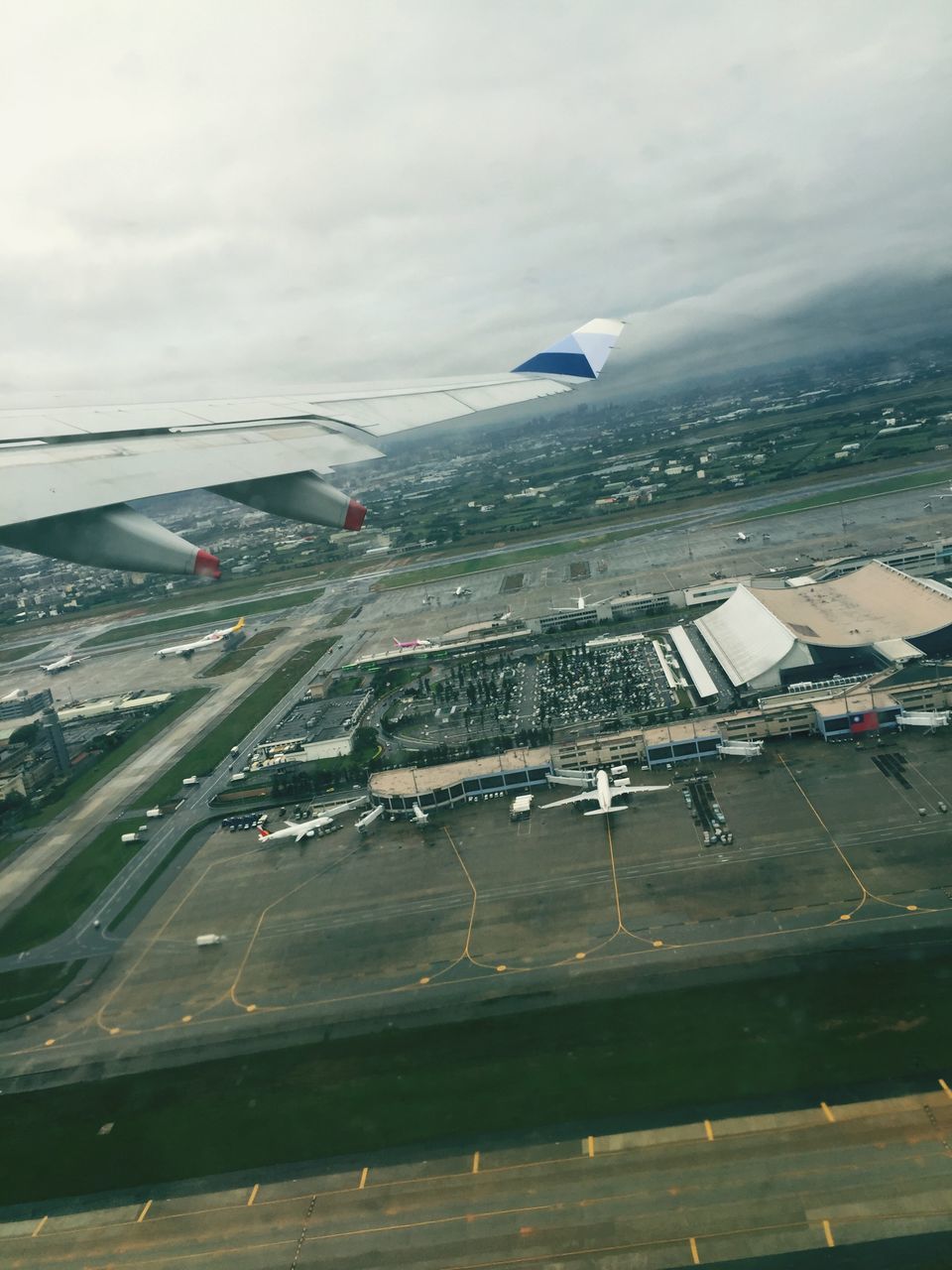 airplane, air vehicle, flying, transportation, sky, mode of transport, cloud - sky, aircraft wing, aerial view, mid-air, cloudy, building exterior, architecture, built structure, landscape, travel, weather, cloud, nature, on the move