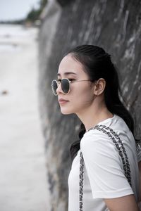 Portrait of woman wearing sunglasses standing outdoors