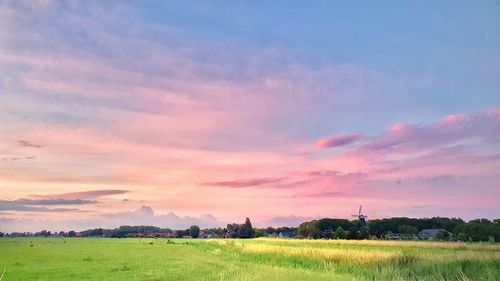 Scenic view of field against sky during sunset