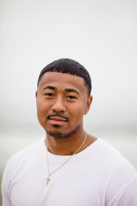 Mixed race man posing at beach