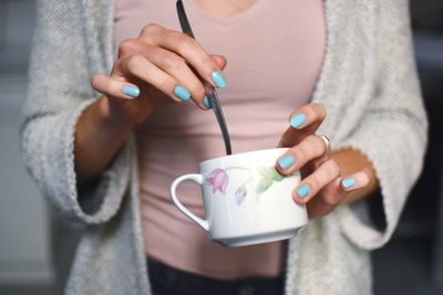 Close-up of young woman holding mobile phone