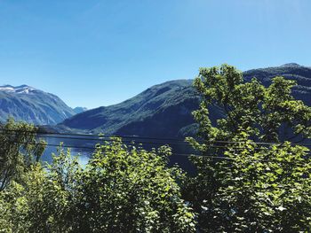 Scenic view of mountains against clear blue sky