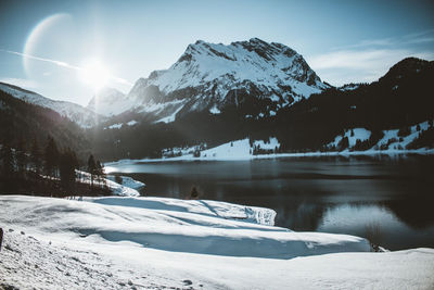 Scenic view of snowcapped mountains against sky during winter