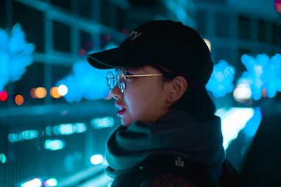 Close-up portrait of boy looking away at night