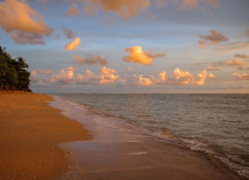 Scenic view of beach against sky during sunset
