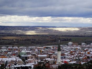 High angle view of houses in town against sky