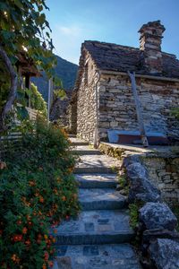 Footpath amidst old building against sky