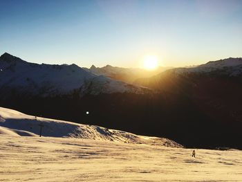 Scenic view of mountains against clear sky during sunset