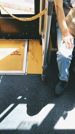 Low section of man sitting on street