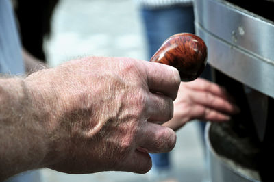 Close-up of man holding smoking pipe