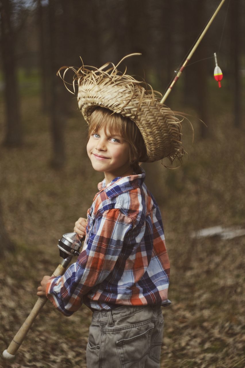 childhood, child, one person, focus on foreground, real people, leisure activity, boys, standing, portrait, casual clothing, holding, innocence, cute, land, lifestyles, looking at camera, day, girls, stick - plant part, outdoors