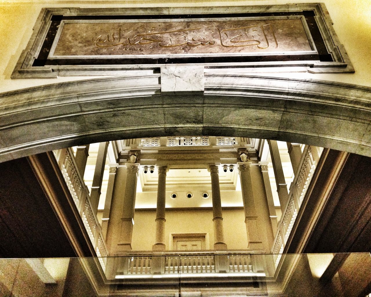 architecture, built structure, building exterior, low angle view, indoors, railing, building, railroad station, staircase, steps and staircases, steps, architectural column, rail transportation, city, transportation, no people, subway station, modern, day, architectural feature