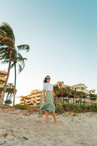 Rear view of woman standing at beach