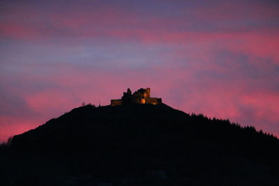 Silhouette of built structures at sunset