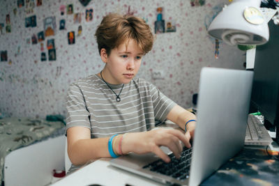 Young woman using laptop at home