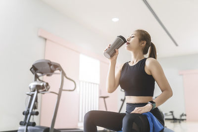 Young woman with arms raised