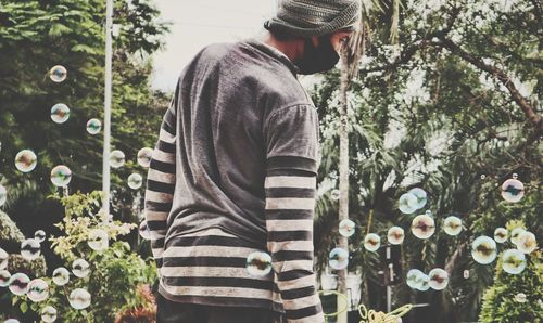 Midsection of man standing by plants