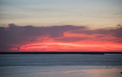 Scenic view of sea against romantic sky at sunset