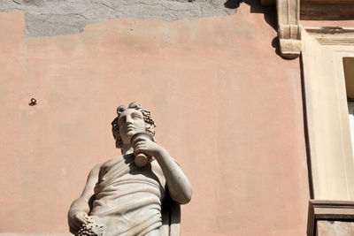 Low angle view of statue against wall