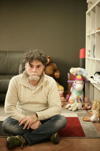 Portrait of man sitting in playroom