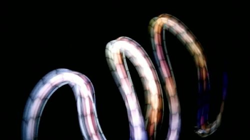 Close-up of light trails over black background