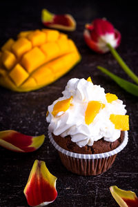 Close-up of cupcake and fruit on table