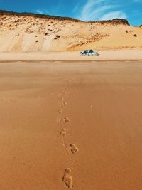 Sand dunes in desert against sky