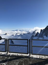 Scenic view of snowcapped mountains against blue sky