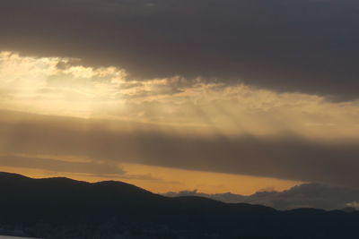 Scenic view of silhouette mountains against sky during sunset