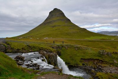 Scenic view of waterfall against sky