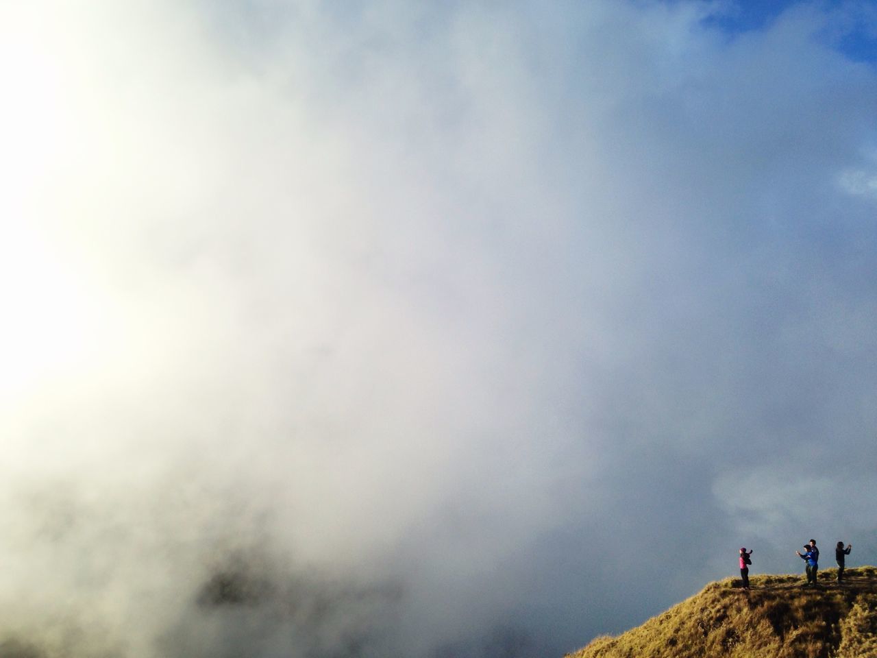 sky, cloud - sky, lifestyles, leisure activity, cloudy, men, scenics, low angle view, tranquility, weather, tranquil scene, nature, beauty in nature, cloud, overcast, person, unrecognizable person, standing