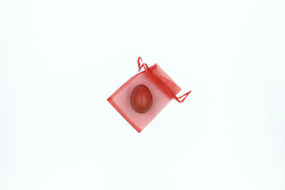 High angle view of red cake against white background