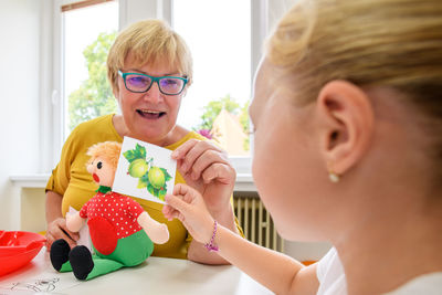 Children speech therapy. preschooler practicing correct pronunciation with female speech therapist.