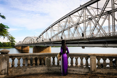 Low angle view of bridge against cloudy sky